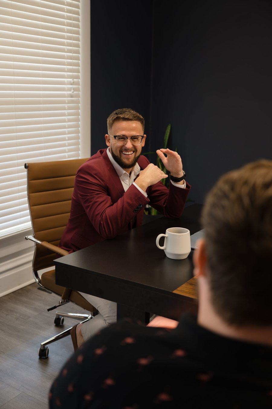 Mitch Gibson talking technology with an agency owner across a conference table